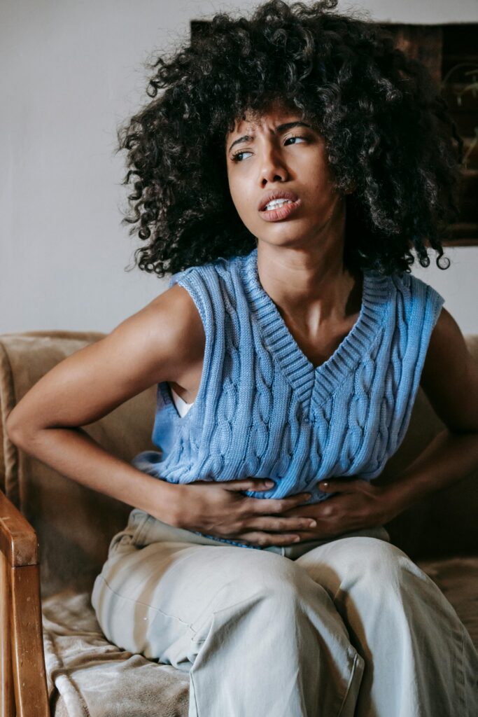 Black woman holding her stomac; Morning Sickness Made Easier: Tips for Moms-to-Be