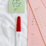 An image of a positive pregnancy test with a calendar, speculating a due date